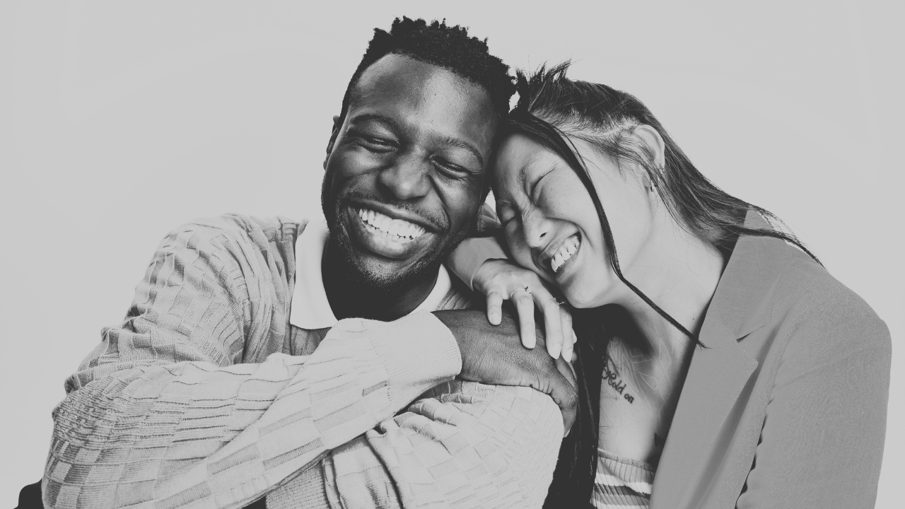 Two young adults smiling together